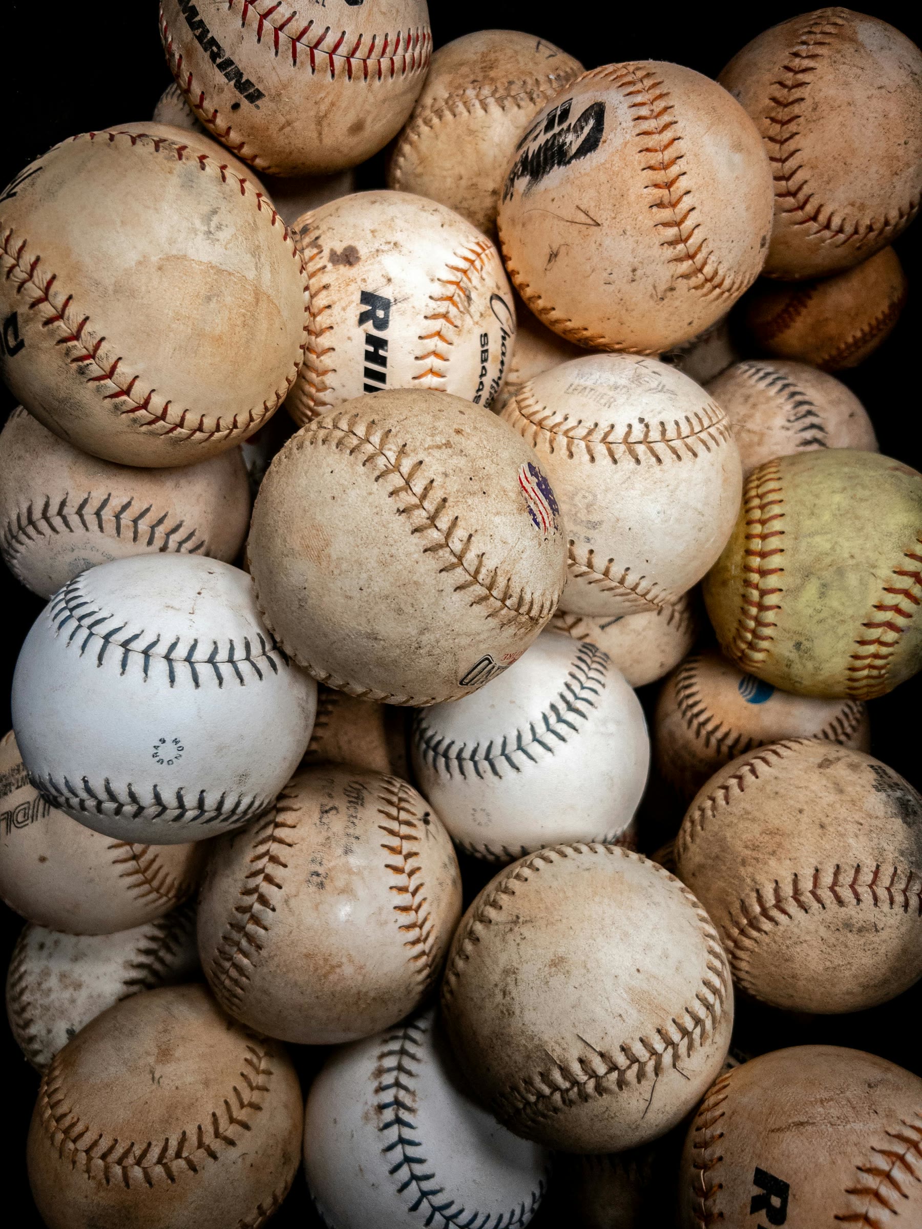 Pile of worn baseballs