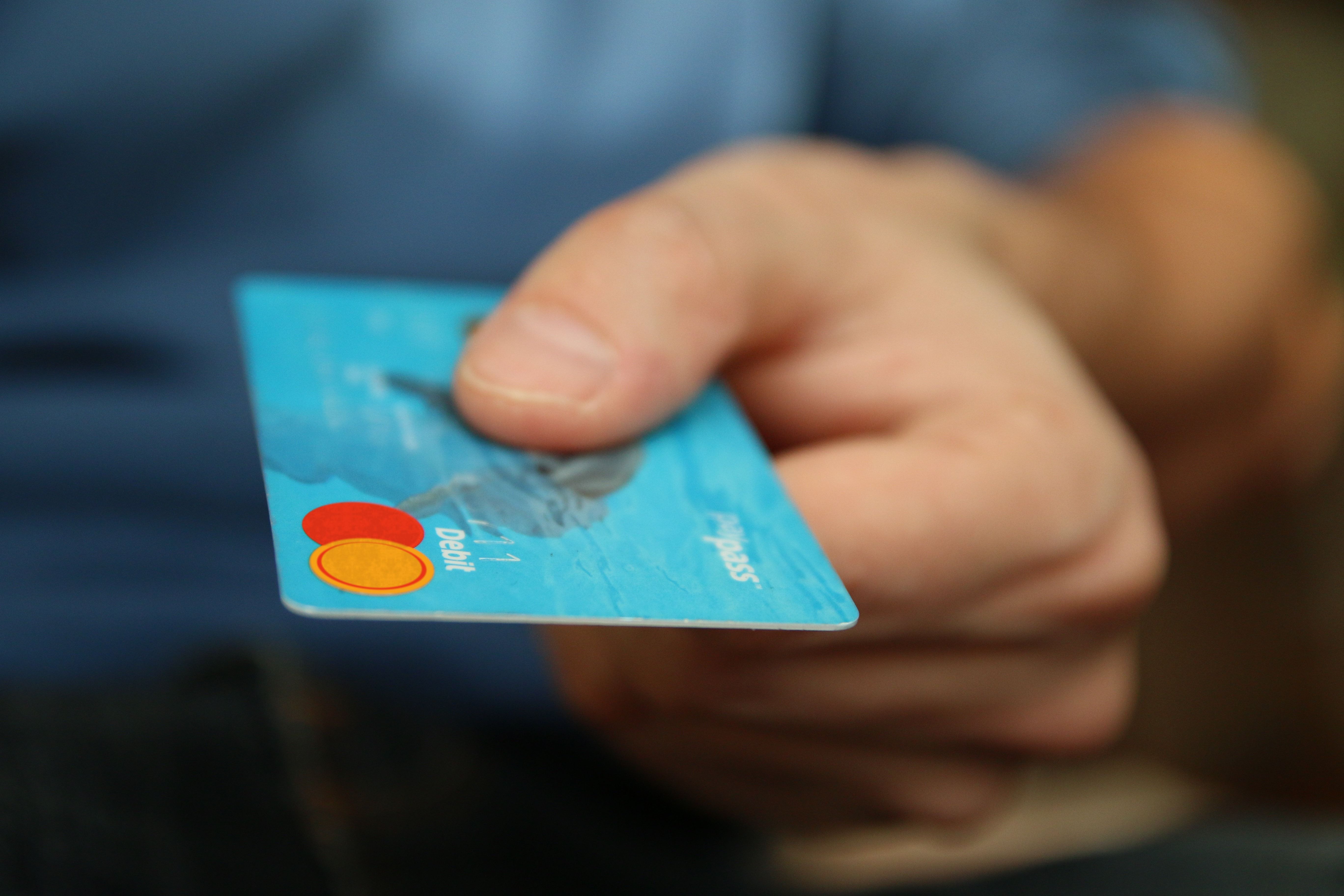 Hand holding a debit card